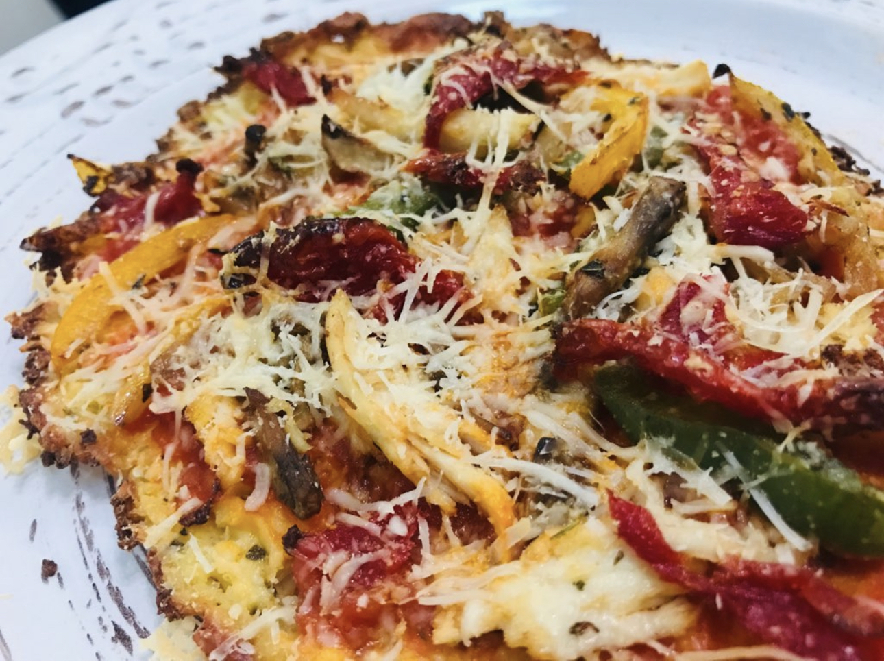 Low carb, cheese based, flourless pizza with vegetable toppings