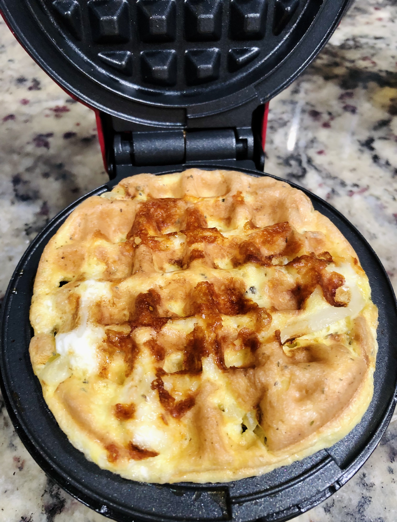 Cooked pizza chaffle in a mini waffle maker