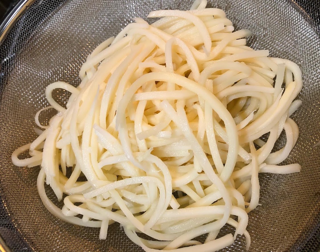 Palmini Hearts of palm linguine in a strainer before it is cooked