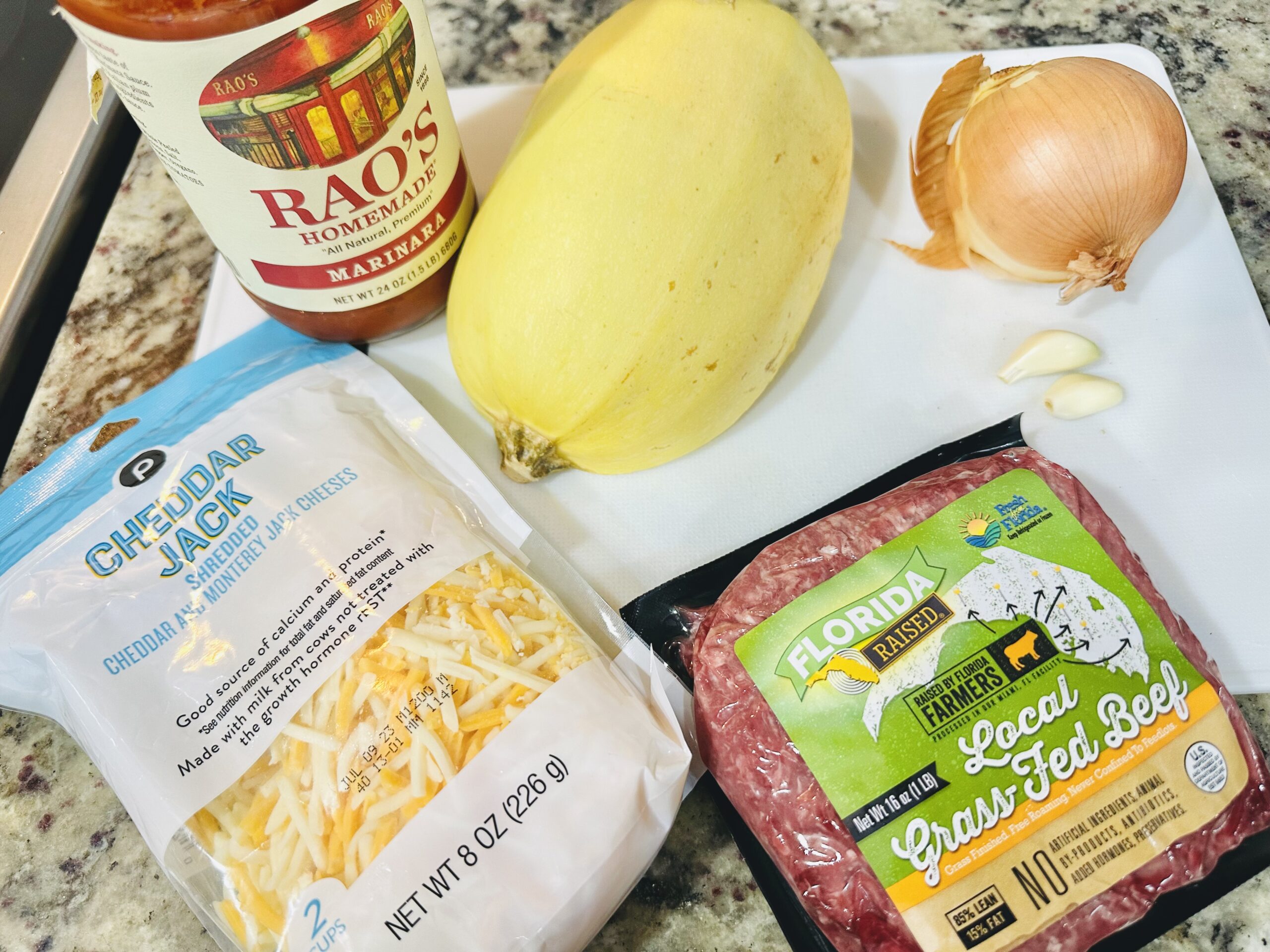 Butternut squash and various cooking ingredients on a cutting board 