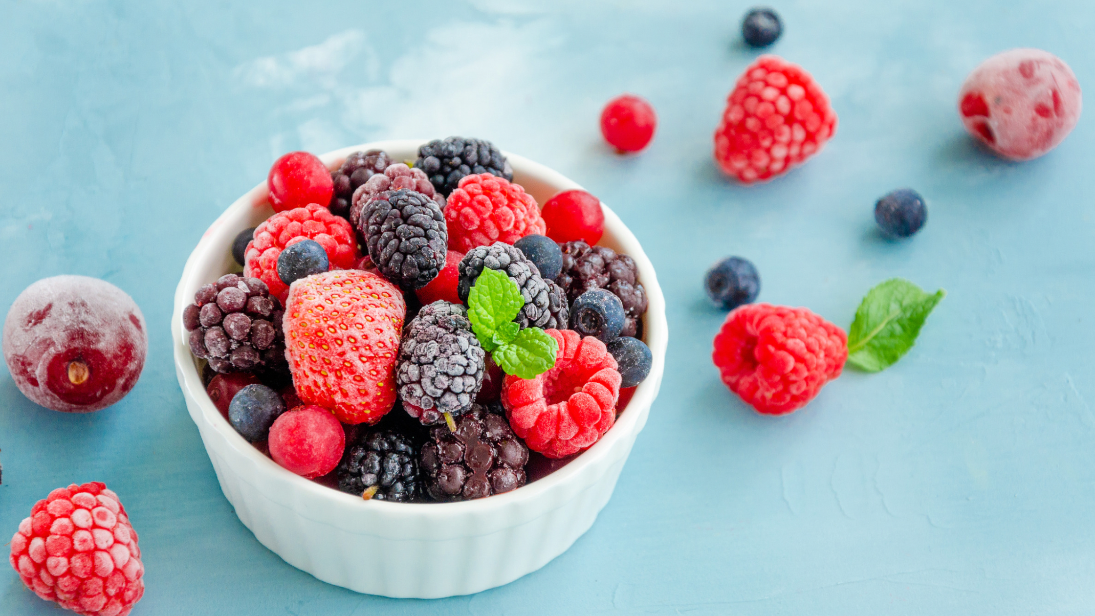 Mixed berries in a small white ceramic bowl