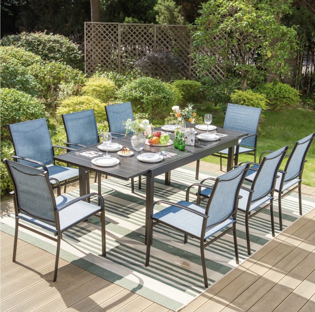 An dark wood outdoor table with 8 light blue chairs on a patio