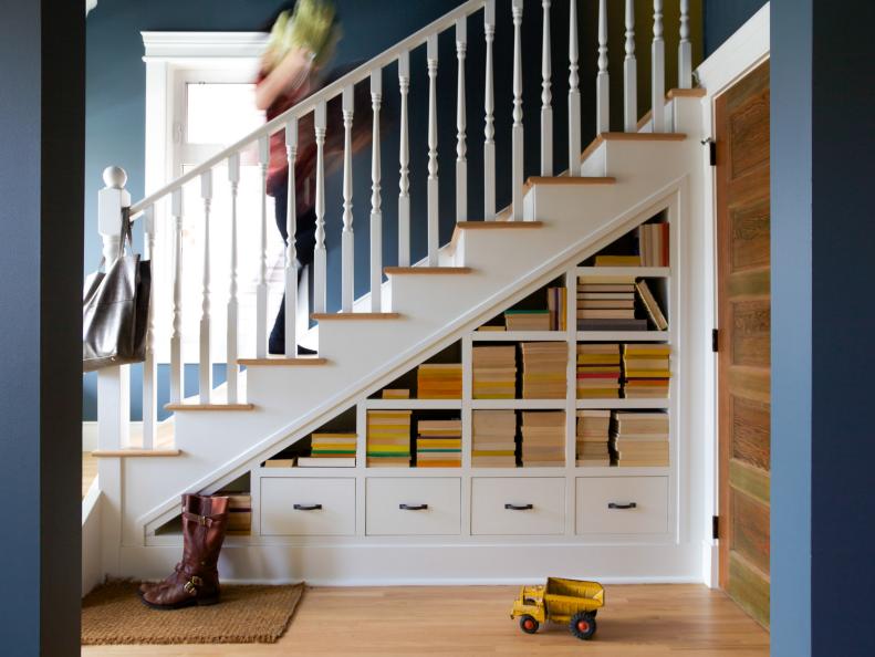 staircase with book storage and drawers underneath