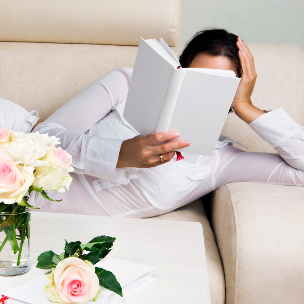 Woman relaxed on a couch reading a book