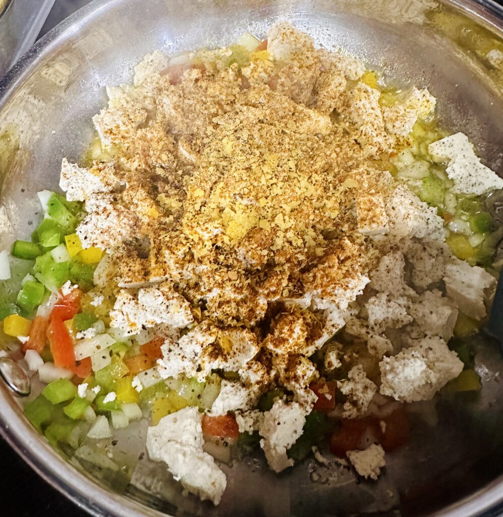 Skillet filled with vegan tofu scramble and seasonings