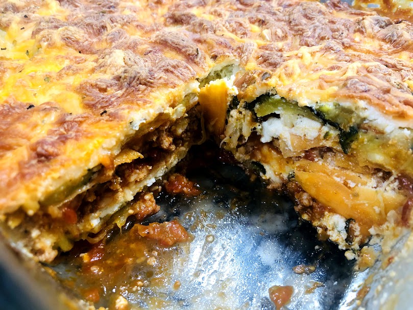 Photo shows layers of zucchini and sweet potato lasagna, not soggy and a square cut out