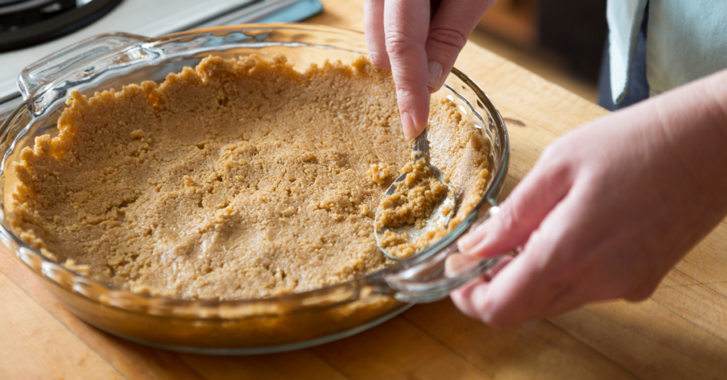 Graham cracker crust in a glass pan