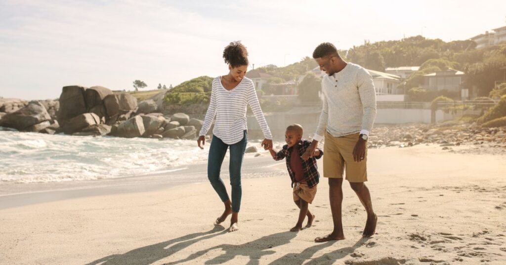 family walking on a beach outdoors, relaxed