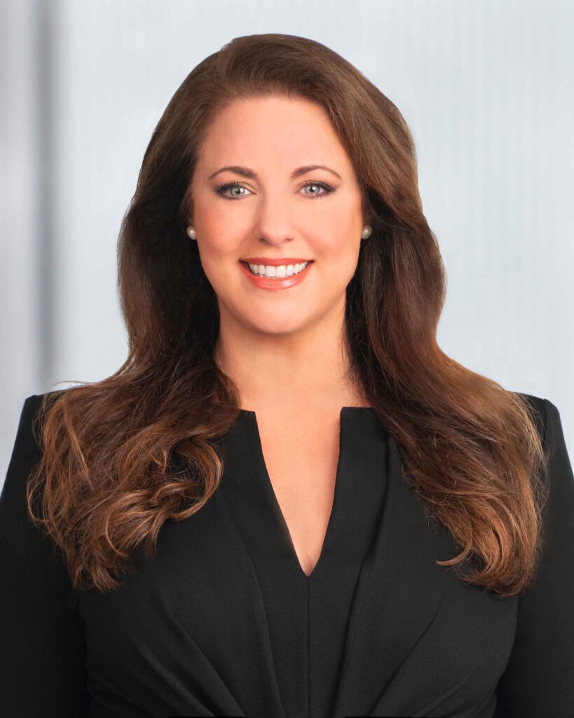 Professional photo of a woman, Katie L. Lewis in a suit.