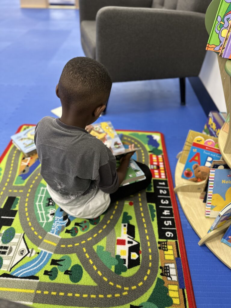 A child reading in a colorful room_date night kids gym option